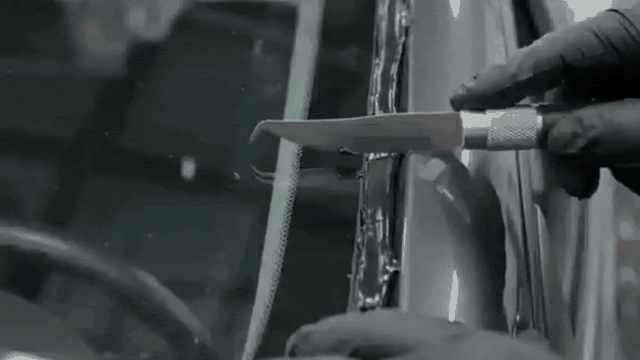 Bead of urethane adhesive being applied evenly around a frame before a new windshield is installed.